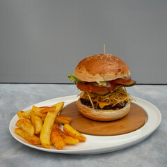 Freshly baked burgers and chips on a gray and blue background