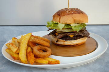 Freshly baked burgers and chips on a gray and blue background