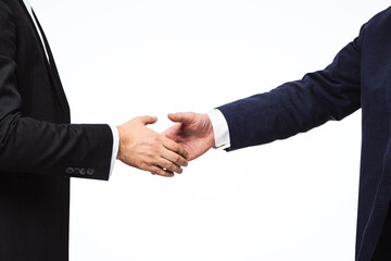 Two businessmen shake hands on a white wall background, deal concept, close up