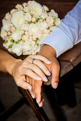Obraz na płótnie Canvas wedding background bride and groom hands with rings