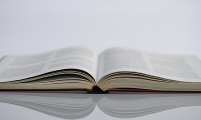 the reflection of a book on a white table