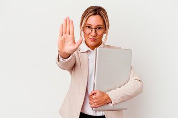 Young caucasian business woman holding a laptop isolated on white background standing with outstretched hand showing stop sign, preventing you.