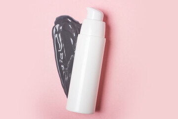 White cosmetic jar, on the background of smeared cream or cosmetic face mask. Purifying and moisturizing clay mask. Top view, flat lay