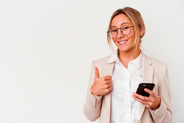 Young caucasian business woman holding mobile isolated on white background smiling and raising thumb up