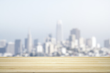 Blank wooden table top with beautiful blurry skyline at daytime on background, mockup