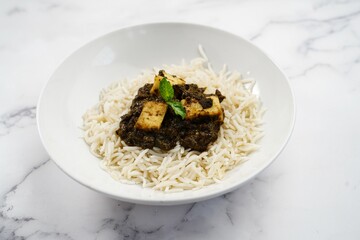 Palak Paneer or Saag Paneer with steamed basmati rice on white background