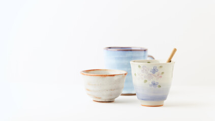 Traditional, handcrafted ceramic on bright wooden background. Soft focus. Copy space.	