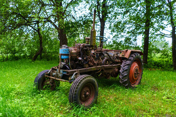 Obraz premium old broken tractor in the field