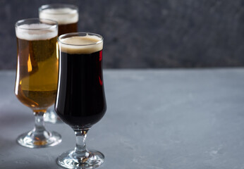 Three different styles of beer on the table close-up. Light beer lager, ale, stout or porter