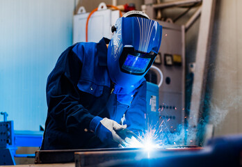 worker grinding a metal plate