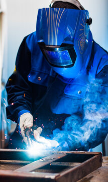 worker grinding a metal plate