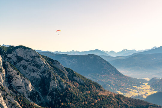 Paragliding flying over mountain peaks, Altaussee, Liezen, Styria, Austria
