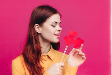 happy woman with paper hearts on sticks pink background Valentine's day