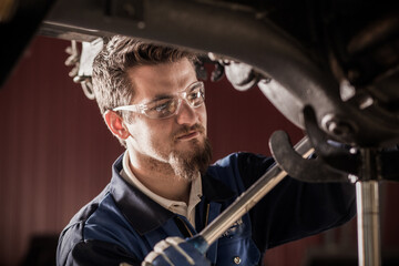 Fototapeta na wymiar car mechanic at work in a garage