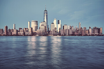 Fototapeta na wymiar New York City skyline with buildings reflecting last sunlight, color toning applied, USA.