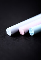 Soft pastels on dark (black) background. Close up.
