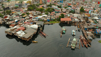 Fototapeta na wymiar Slum area in Manila, Phillippines, top view. lot of garbage in the water.