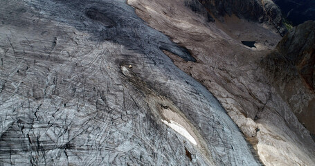 The Marmolada glacier in summer: Aerial view of the last and the only glacier of the Dolomites, UNESCO heritage, near the town of Canazei - August 2018 - Evidence of global warming and melting glacier