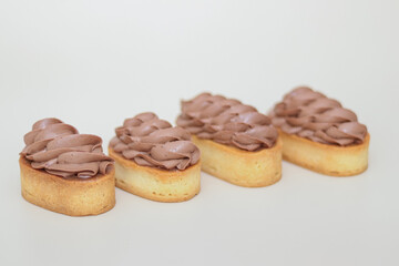 Shortcrust tartlets with chocolate cream on a light background