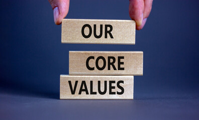 Our core values symbol. Concept words 'Our core values' on wooden blocks on a beautiful grey...