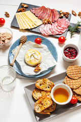 Antipasto platter cold meat with bread, salami, slices ham and cheese on wooden background