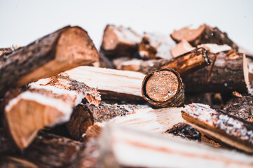 Wooden natural sawn logs as background. Wood texture. Firewood close up. Pine wood.