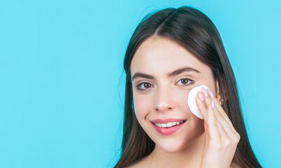 Fototapeta premium Beautiful brunette woman with clean perfect fresh skin using cotton pad skin care concept. Concept of beauty, health treatment. Cosmetology and spa. Using makeup sponge. Portrait woman using sponge