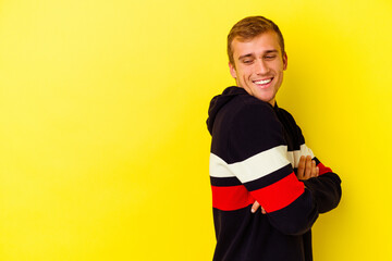 Young caucasian man isolated on yellow background