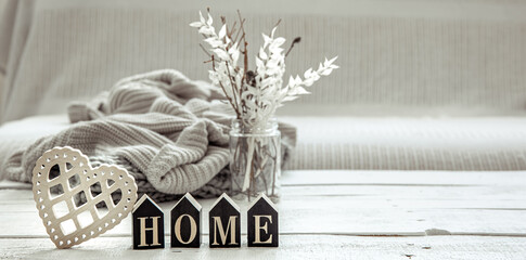 Cozy composition in Scandinavian style with decorative word home and decor details.