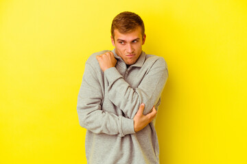 Young caucasian man isolated on yellow background