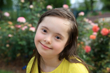 Young girl on the background of roses