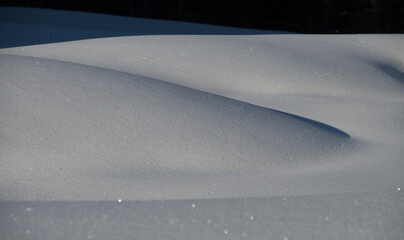 snowscape winter scenic landscape of snow mounds or snow drifts close up with shadows from sunlight...