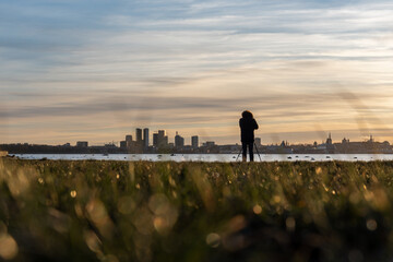 Photographer on a blurry city background. Tallinn cityscape.