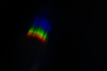 spectral light flare on a dark background blurred image, rainbow