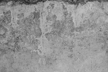 Gray concrete wall, old surface with peeling plaster. Building board texture. Vintage background close-up