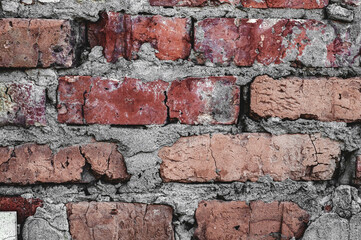 Obraz premium Background old surface, vintage cracked wall, red handmade brick close-up, grungy texture.