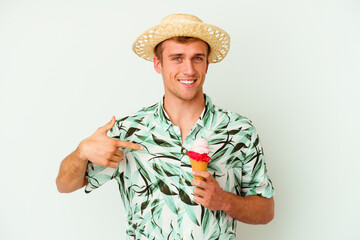 Young caucasian man wearing a summer clothes and holding a ice cream isolated on white background