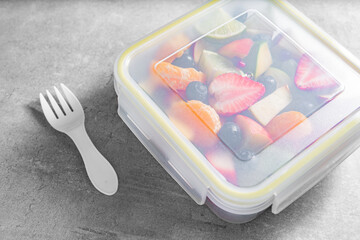 Packed fruit salad in plastic box. Healthy meal to go
