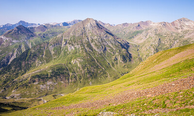 Beautiful summer scenery from the top of a mountain, with green meadows and high peaks
