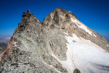 Snow-capped mountain top surrounded by a glacier