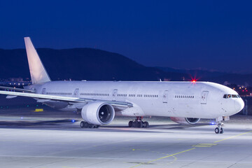 white long haul aircraft starting up the engines at night