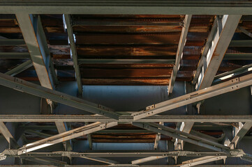 view of a structure of gray metal railway bridge for train, down to up. Old railway bridge over the...