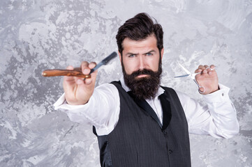caucasian bearded hairstylist with retro barber razor and scissors, selective focus, hairdresser.