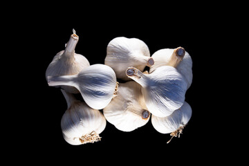 Pile of garlic on a black background. Photo with shallow depth of field.