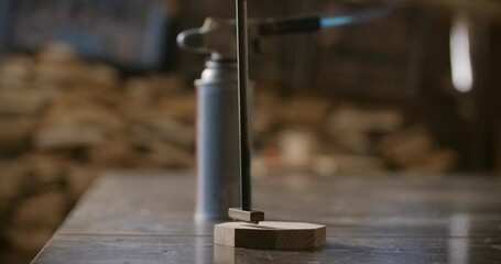Carpenter puts hot stamp with red-hot tool to the wooden product with smoke in slow motion, marking the final product, 4k 60p Prores 422 HQ 10 bit