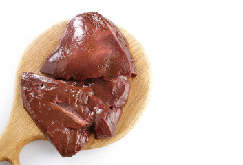 Raw liver on wooden board on white background top view, high angle.