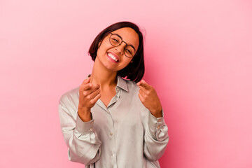 Young mixed race woman isolated on pink background cheerful smiles pointing to front.