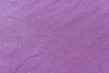 abstract background of an old purple knit fabric close up, shallow depth of field