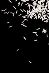 Heap of white rice isolated on black background. rice close-up.