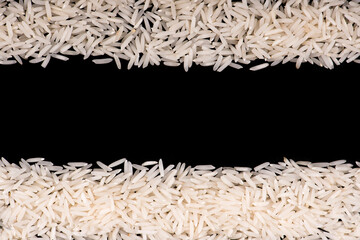 Heap of white rice isolated on black background. rice close-up.